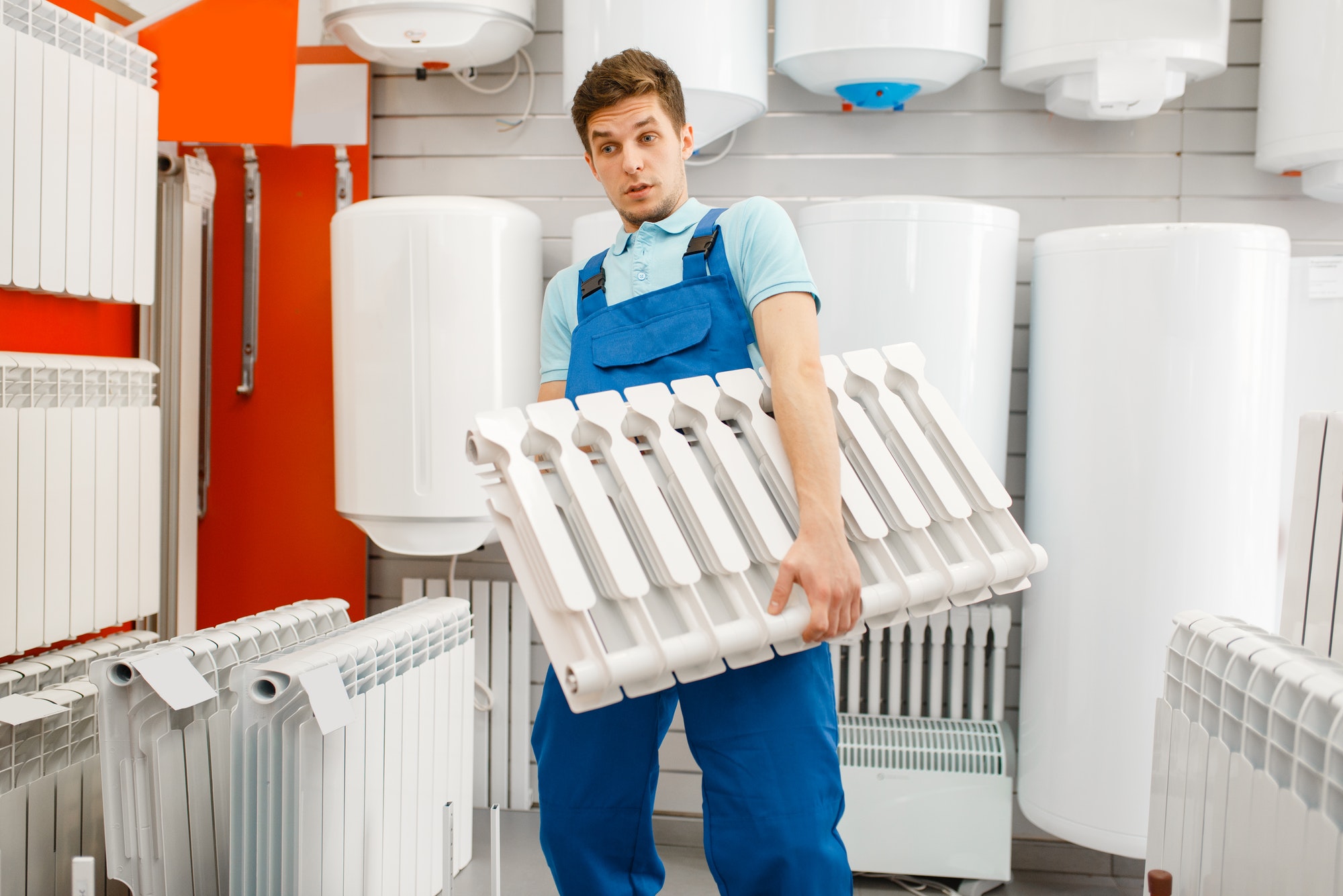 plumber-holds-water-heating-radiator-plumbering.jpg